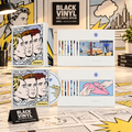 Edición CD con postales de Dreamers de Take That en una escena de cómic